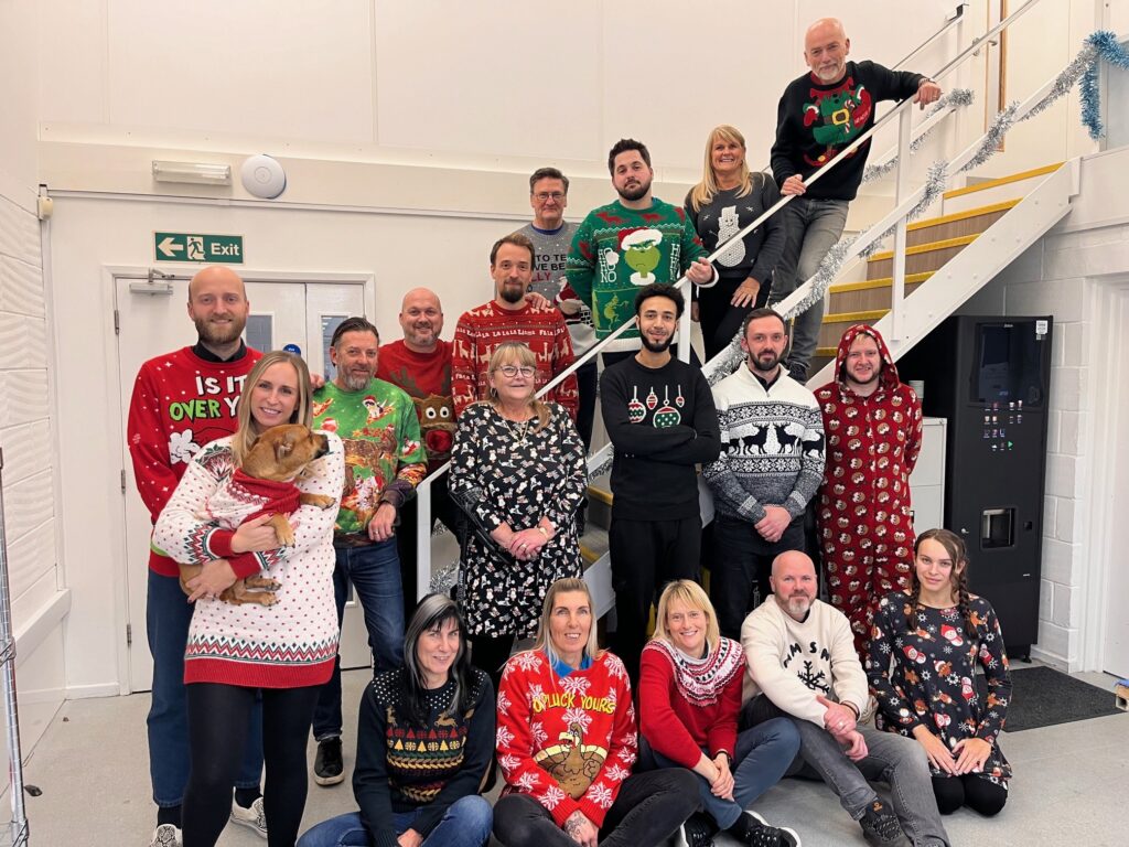 Image of Panel Graphic staff wearing Christmas jumpers in support of Save The Children jumper day