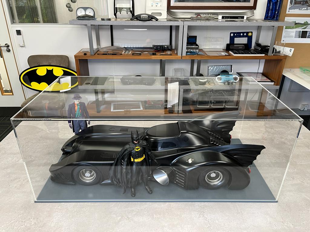 A display case with a vintage batman car inside, case made using acrylic fabrication tecniques